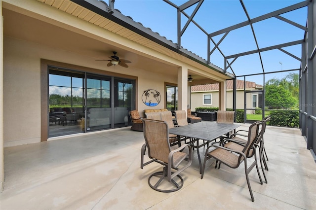 view of patio / terrace featuring ceiling fan and glass enclosure