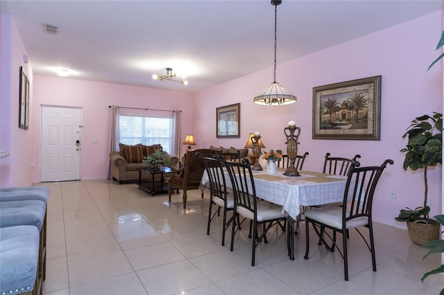 dining room with a notable chandelier and light tile patterned floors