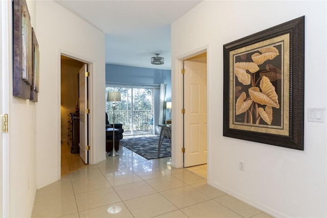 hall featuring light tile patterned flooring