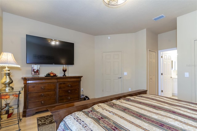 bedroom featuring light hardwood / wood-style floors and a closet