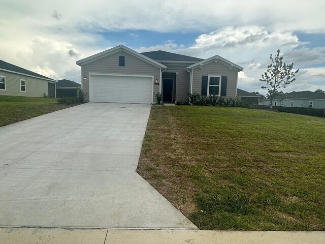 view of front of house featuring a garage and a front lawn