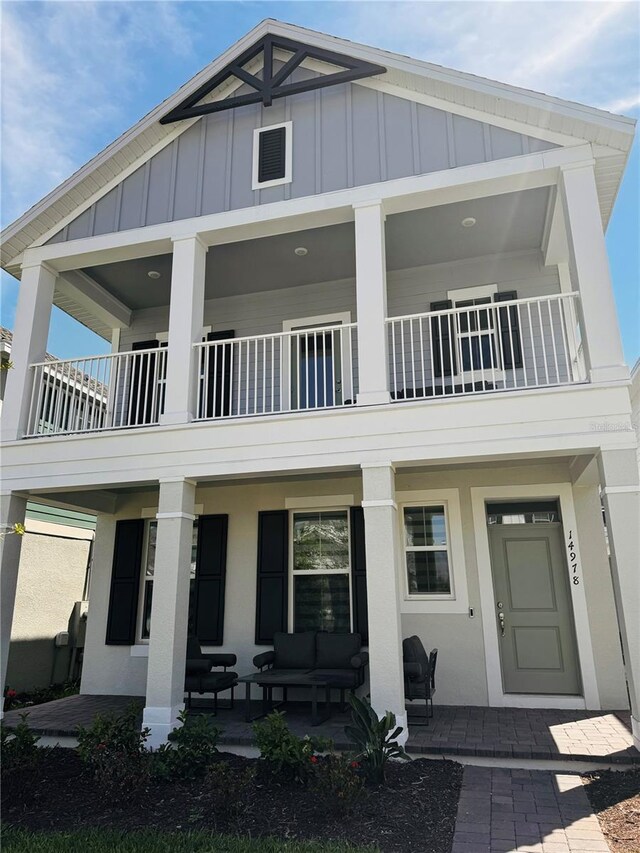 view of front facade featuring a balcony and an outdoor living space