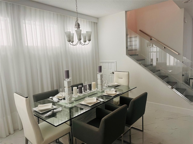 dining area with an inviting chandelier and tile patterned floors