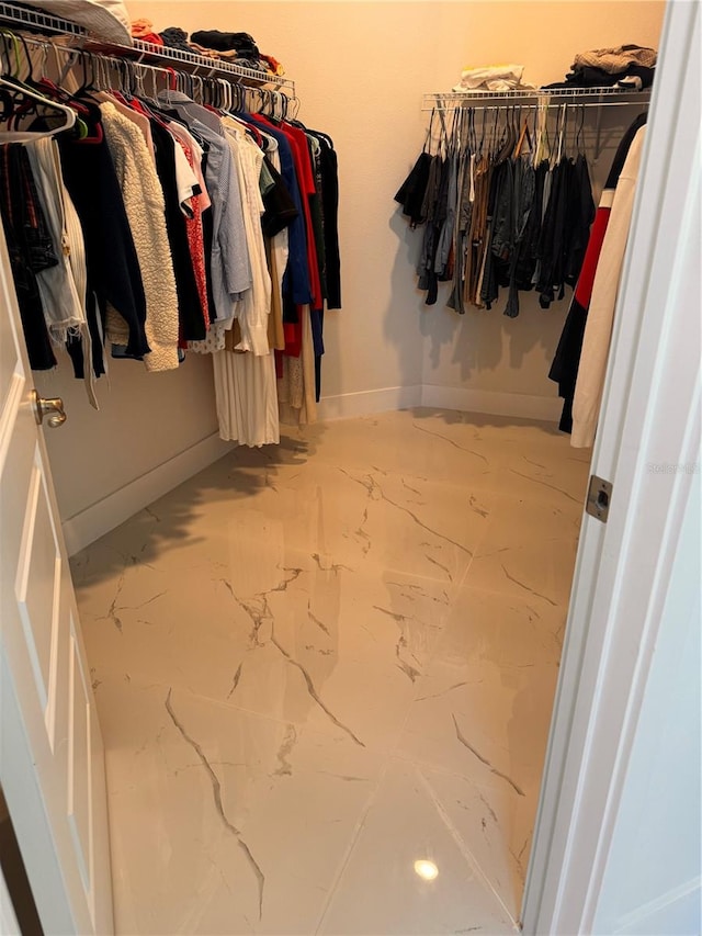 walk in closet with tile patterned floors