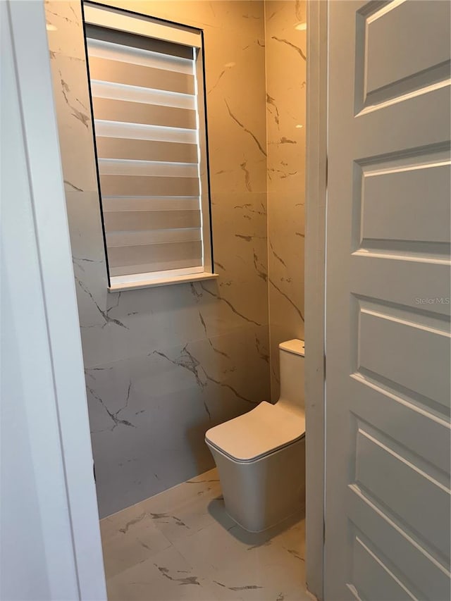 bathroom with tile patterned flooring and toilet