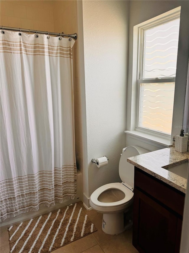 full bathroom featuring vanity, shower / tub combo with curtain, toilet, and tile patterned floors