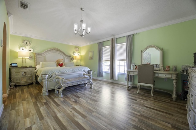 bedroom featuring a chandelier, a textured ceiling, dark hardwood / wood-style flooring, and ornamental molding