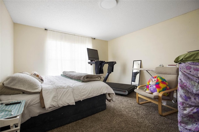 bedroom featuring carpet flooring and a textured ceiling