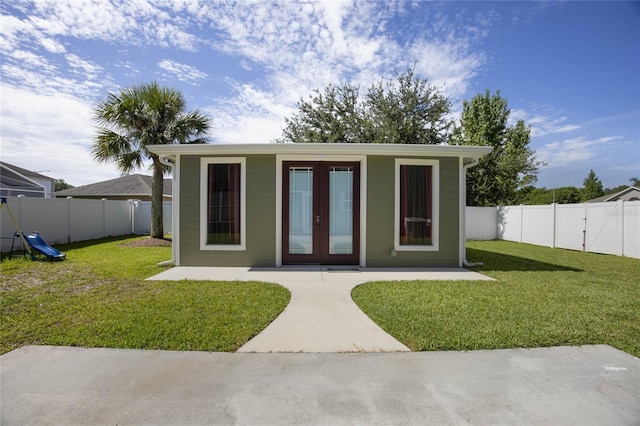 view of outbuilding featuring french doors and a lawn