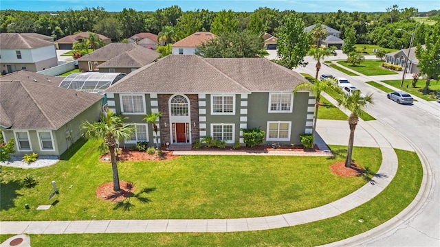5051 Plymouth Turtle Cir, Saint Cloud, FL 34772 - georgian-style home featuring a front yard, a residential view, and stucco siding