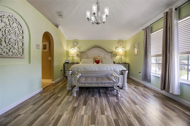 bedroom with a chandelier, hardwood / wood-style flooring, and ornamental molding