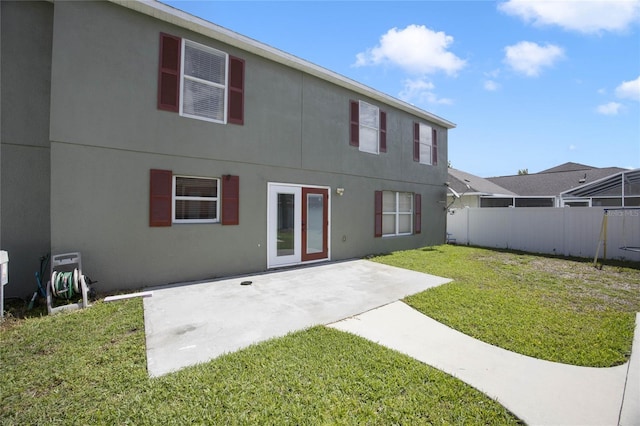 rear view of property featuring a patio area and a yard