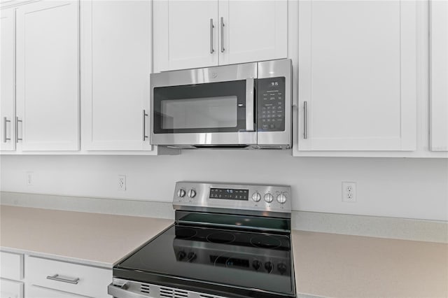 kitchen with white cabinetry and stainless steel appliances