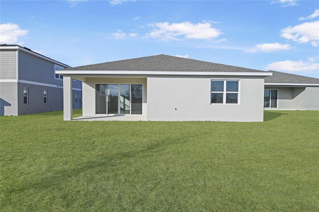 rear view of house with a patio and a yard