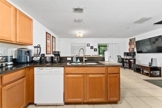 kitchen featuring light tile patterned floors, a textured ceiling, kitchen peninsula, white dishwasher, and sink