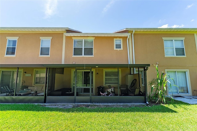 rear view of house with a yard