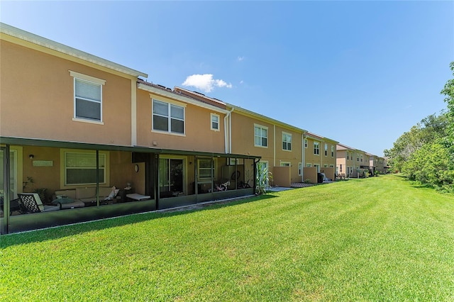 rear view of property featuring a patio and a yard