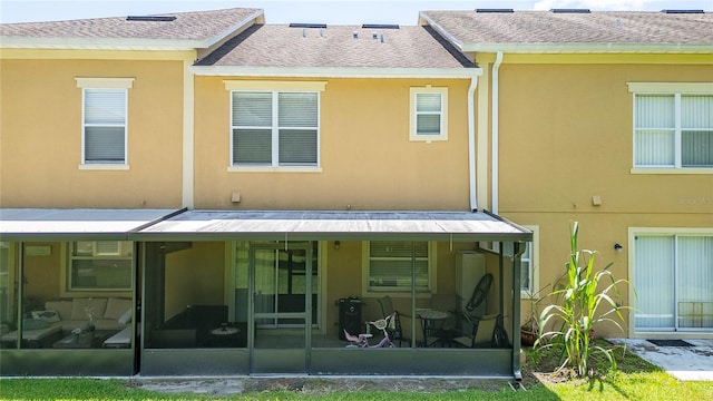 back of property featuring a sunroom