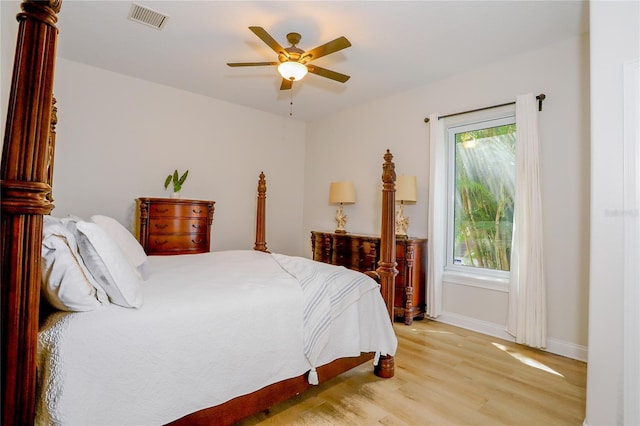 bedroom with multiple windows, ceiling fan, and light wood-type flooring