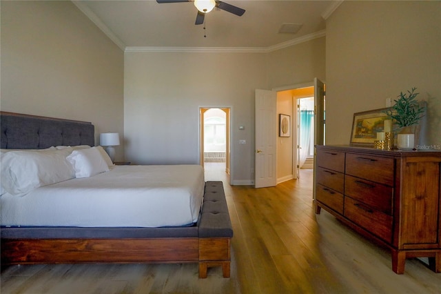 bedroom with light hardwood / wood-style flooring, ornamental molding, and ceiling fan