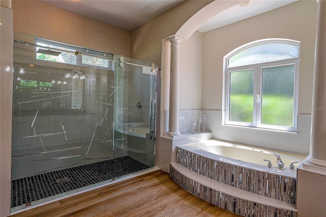 bathroom featuring hardwood / wood-style flooring, plenty of natural light, independent shower and bath, and decorative columns