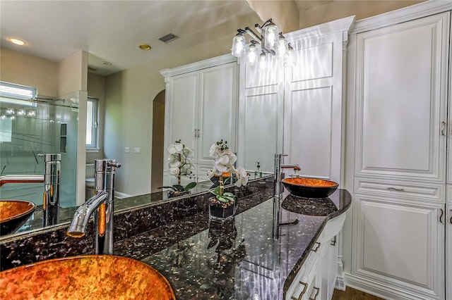 bathroom with walk in shower and vanity