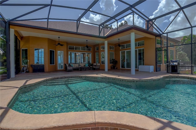 view of pool with a lanai, ceiling fan, outdoor lounge area, a patio, and grilling area