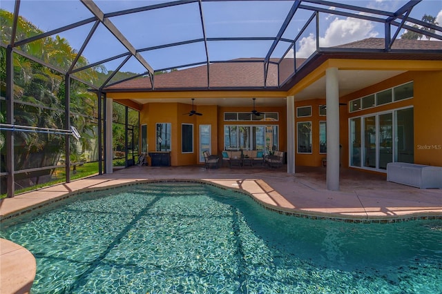 view of pool with ceiling fan, a lanai, and a patio