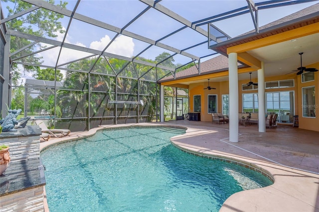 view of swimming pool with a patio, a lanai, and ceiling fan