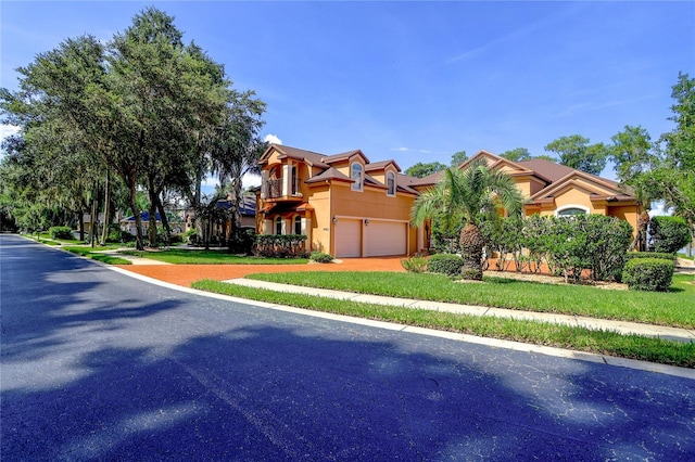 view of front of property with a garage and a front lawn