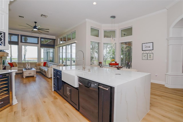 kitchen featuring wine cooler, sink, ornamental molding, dishwasher, and light hardwood / wood-style floors