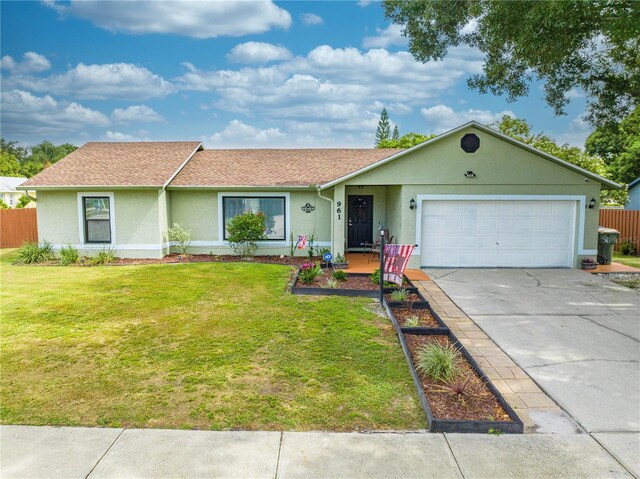 ranch-style home with a garage and a front lawn