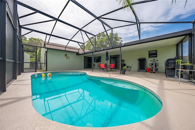 view of swimming pool with a patio and glass enclosure