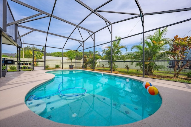 view of swimming pool with a patio area and glass enclosure