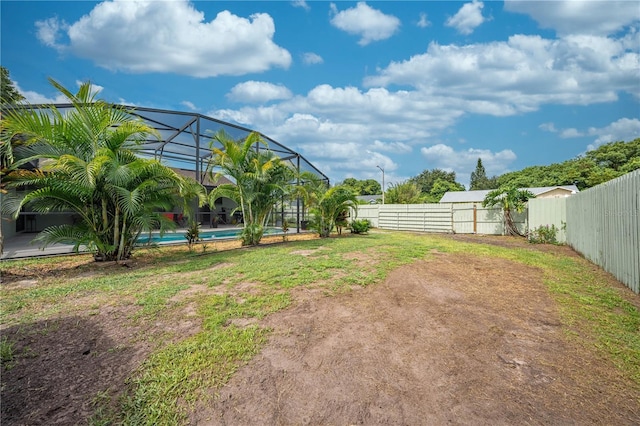 view of yard featuring a fenced in pool and a lanai