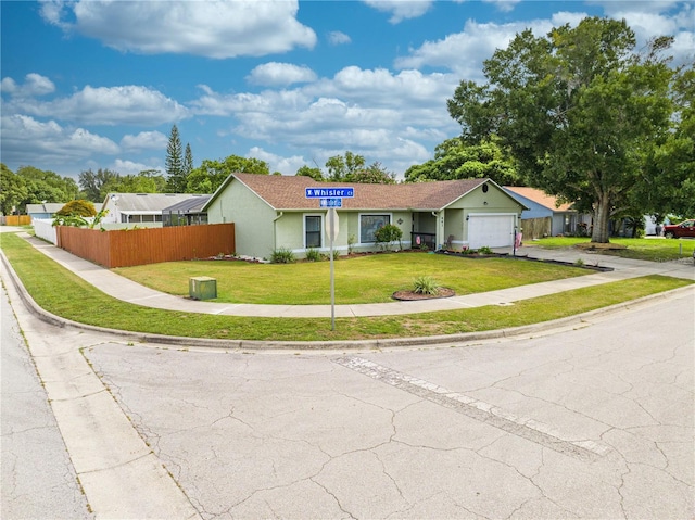 ranch-style house with a garage and a front yard