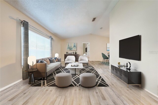 living room with light wood-type flooring, lofted ceiling, and a textured ceiling