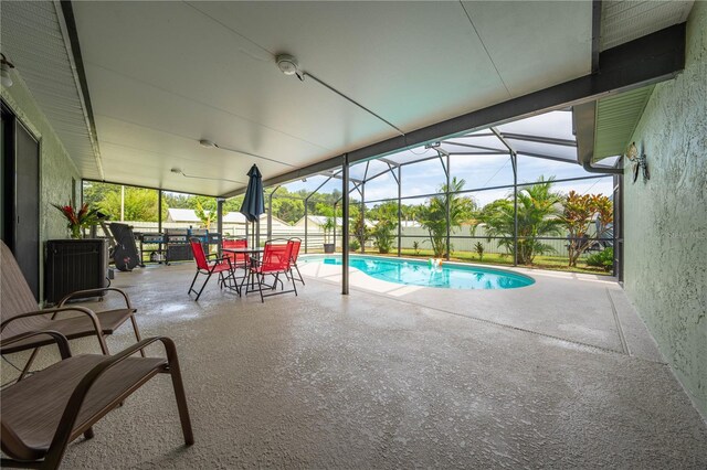 view of swimming pool featuring a patio and glass enclosure