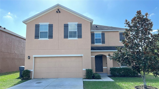 view of front of home with a garage and a front yard