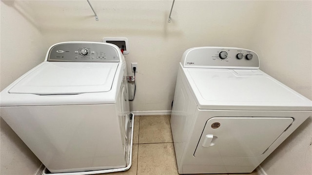 laundry room featuring tile patterned flooring and washer and clothes dryer