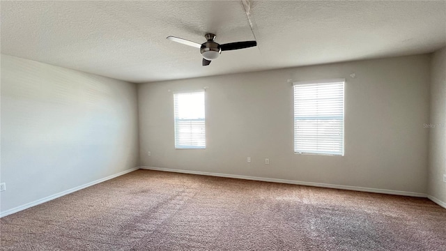 spare room featuring carpet flooring, a textured ceiling, and ceiling fan