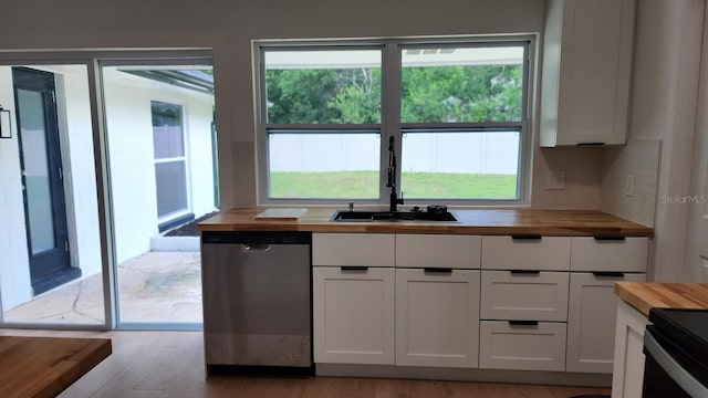 kitchen featuring butcher block counters, sink, dishwasher, light hardwood / wood-style flooring, and white cabinets