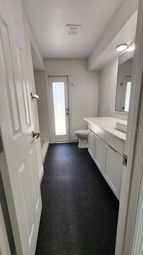 bathroom featuring vanity and toilet