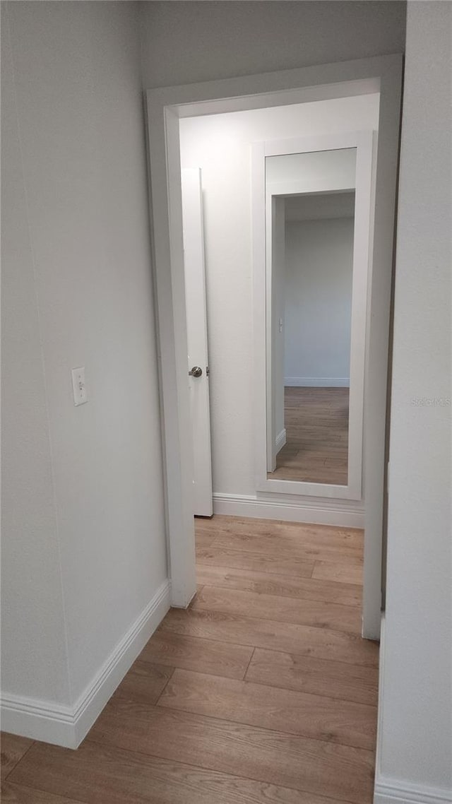 hallway with light hardwood / wood-style flooring