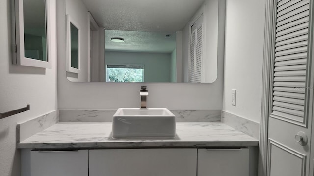 bathroom with vanity and a textured ceiling