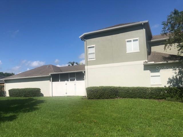 rear view of house with a yard