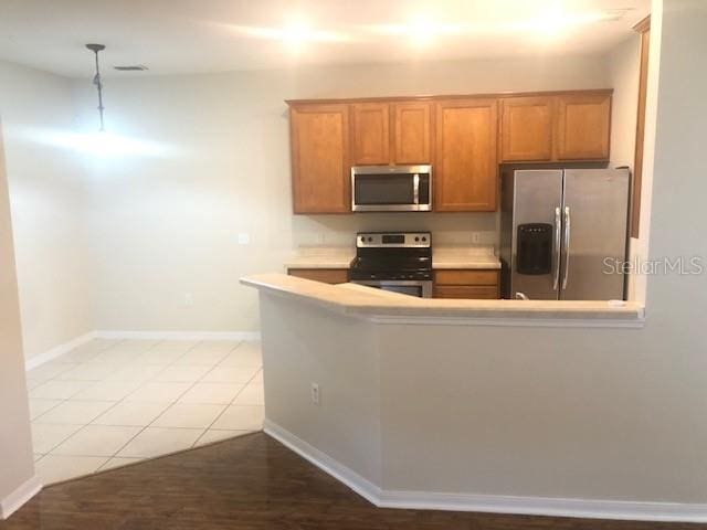 kitchen with tile patterned floors and stainless steel appliances