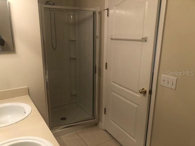 bathroom featuring walk in shower, tile patterned floors, and vanity