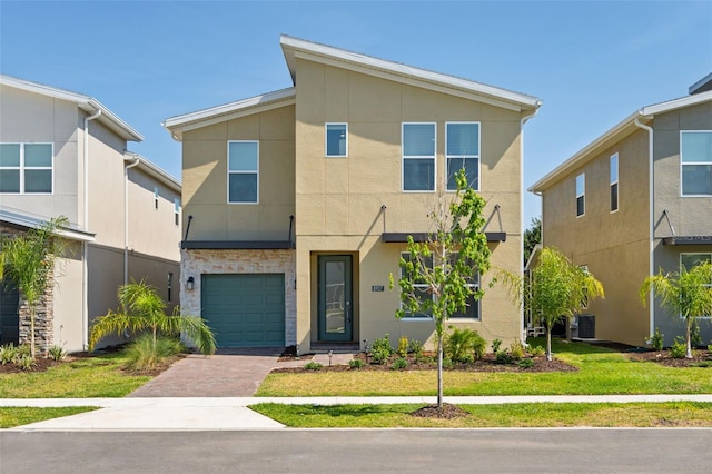 view of front of property featuring a garage and a front lawn