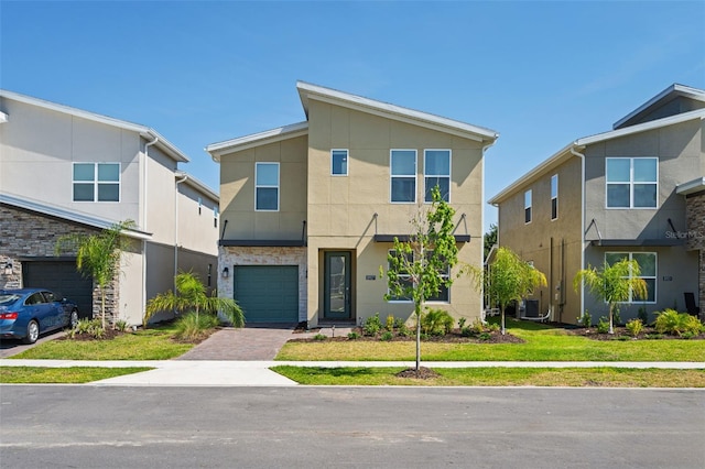 contemporary home with central AC and a front lawn